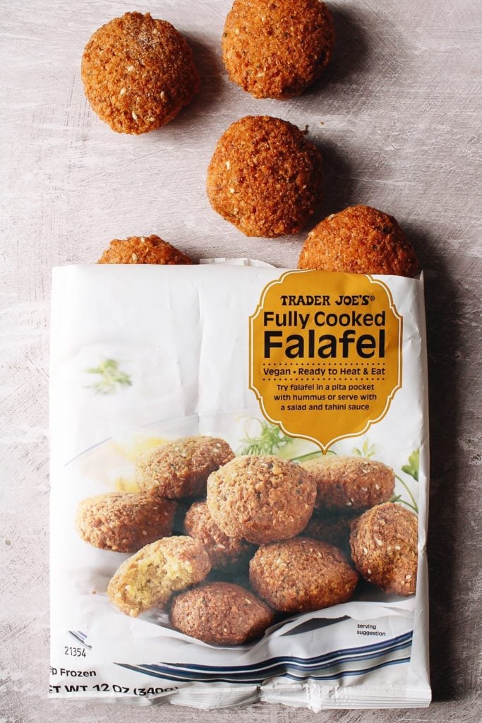 bag of trader joes frozen falafel that is cut open with some falafel coming out of the bag