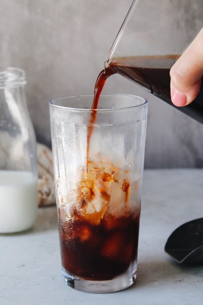 chai concentrate poured into glass with ice
