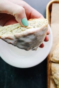 scone being dipped in vanilla bean icing