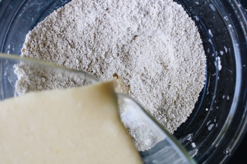 wet ingredients for waffles being poured into dry