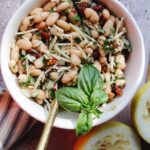 Tuscan White Bean Salad in a Bowl with a Spoon