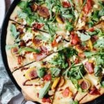 fig and prosciutto pizza in a cast iron flat pan