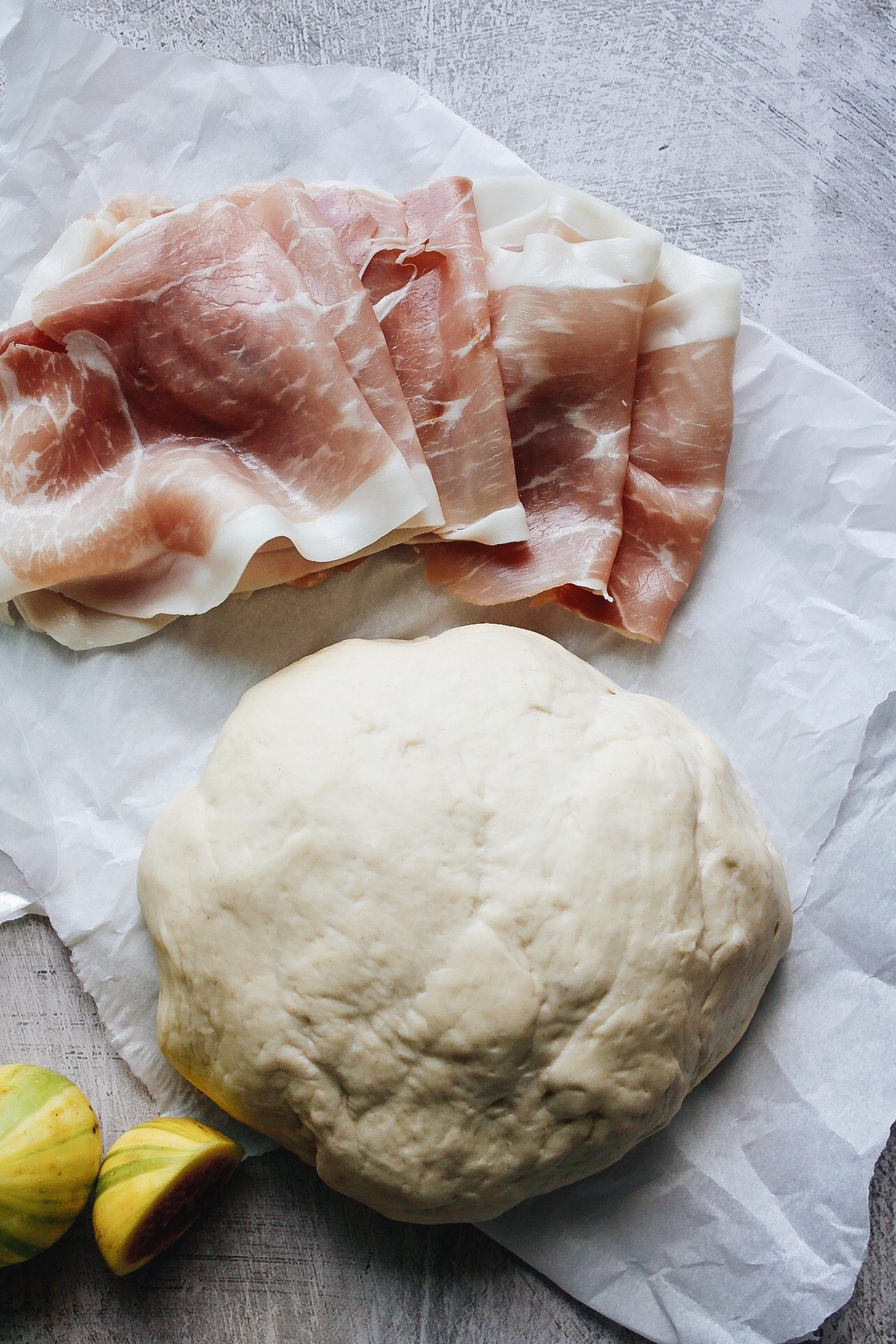 slice prosciutto and fresh pizza dough