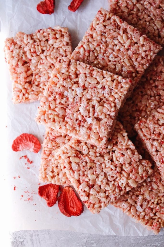 straw berry rice krispie treats on a white piece of parchment paper