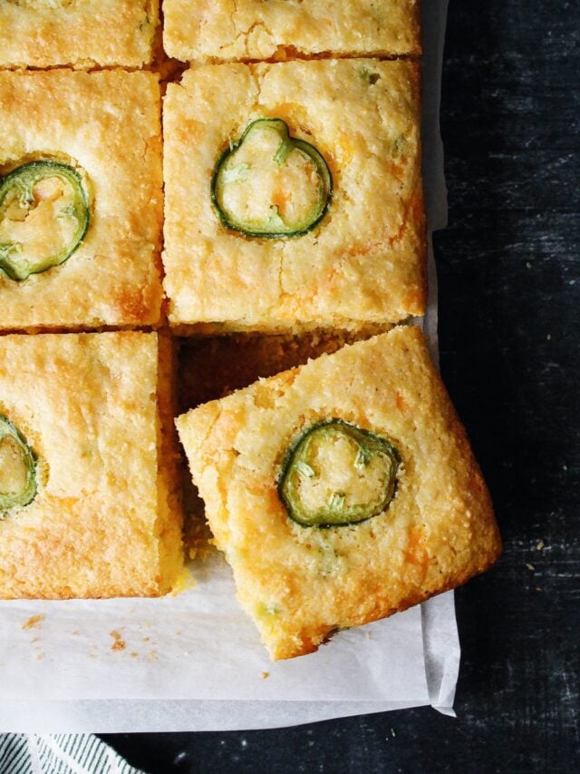 sliced of jiffy jalapeno cornbread on white parchment paper