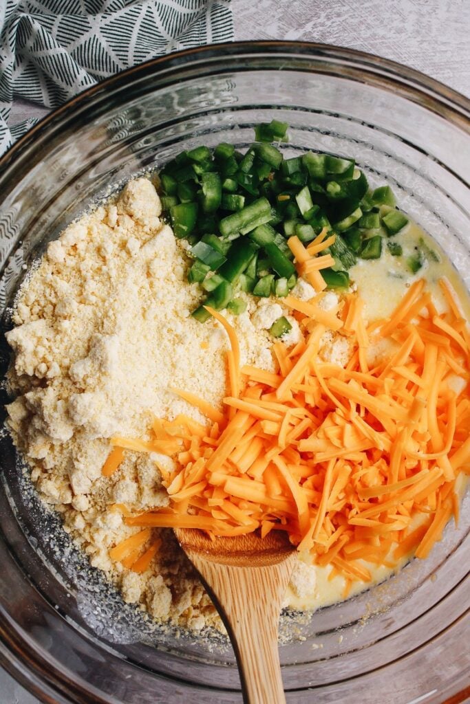 cornbread batter, cheddar cheese, and jalapenos in a mixing bowl