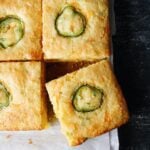 sliced of jiffy jalapeno cornbread on white parchment paper