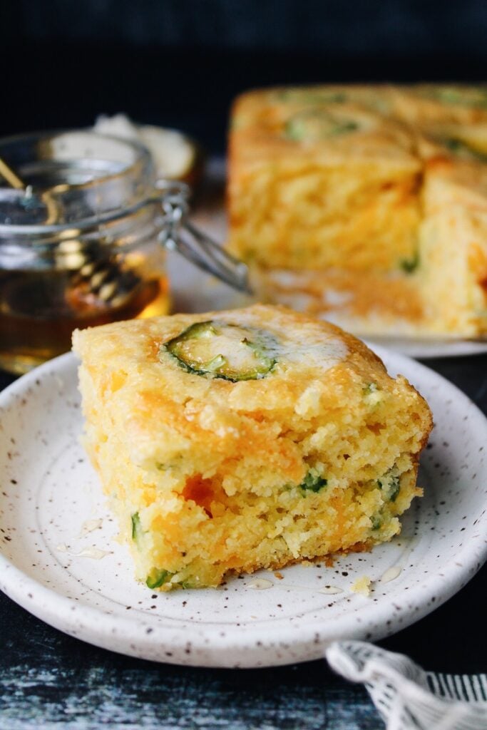 slice of jalapeno cheddar cornbread on a white plate