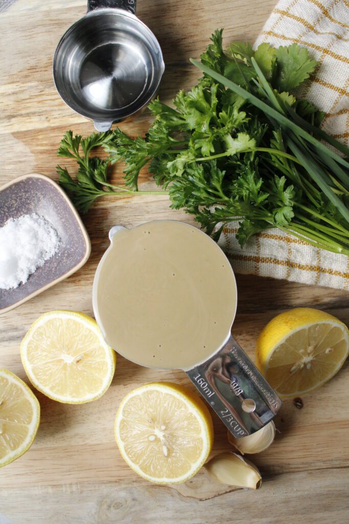 Lemon herb tahini sauce ingredients: tahini, parsley, cilantro, chives, lemon, garlic, salt