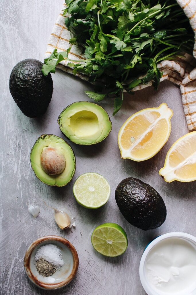 ingredients for avocado cream sauce on a gray background