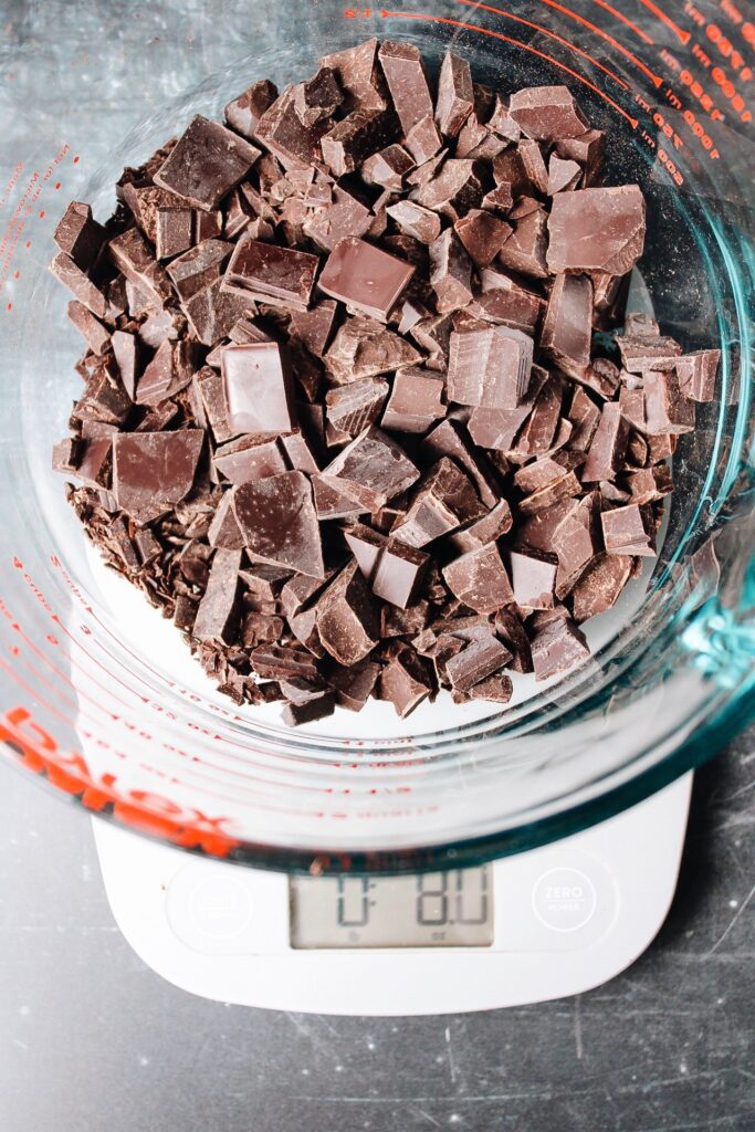 chopped dark chocolate on a baking scale