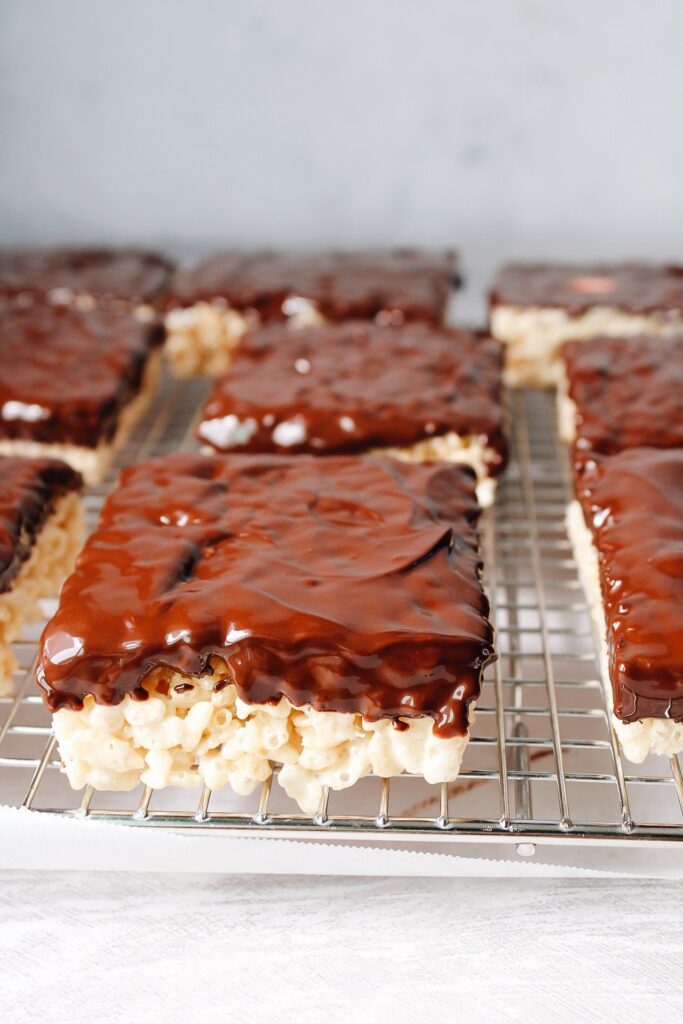 chocolate dipped rice krispie treats on a wire cooling rack