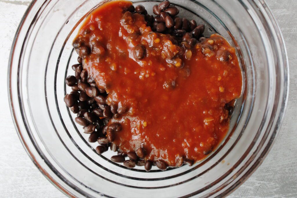 salsa and beans in a glass mixing bowl