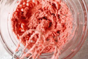 softened butter, powdered sugar and strawberry dust beaten until creamy