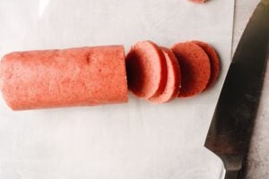 strawberry shortbread cookie dough log cut into 1/2 inch thick slices