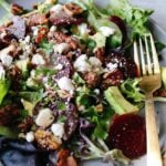 beet and avocado salad on a gray plate with a gold fork