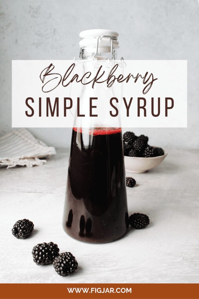 blackberry simple syrup in a tall glass bottle pin