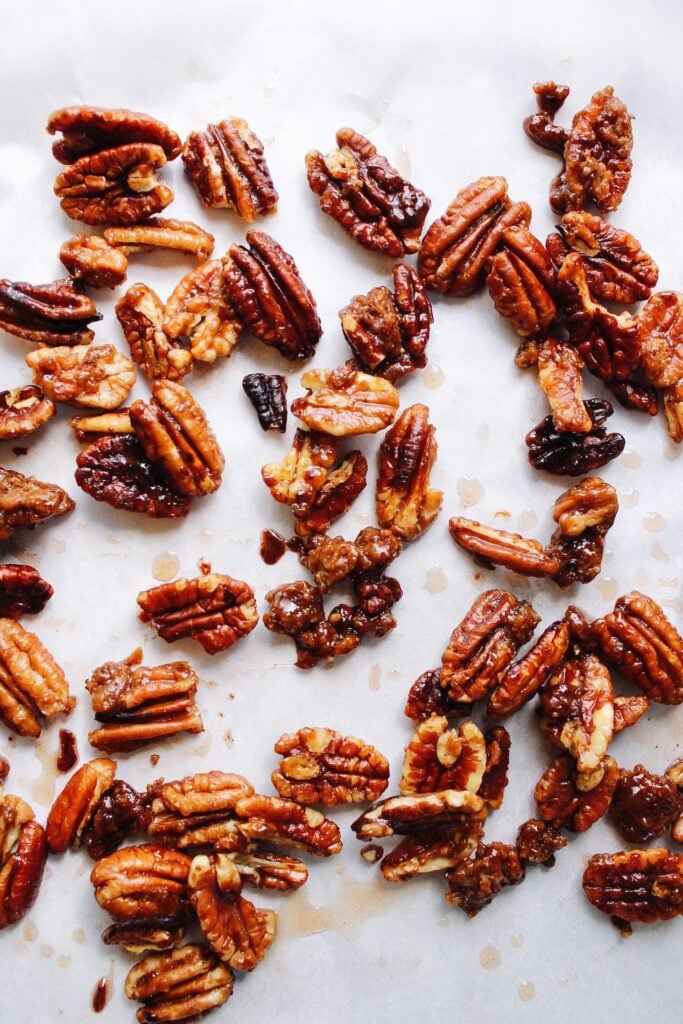 candied pecans on a piece of parchment paper