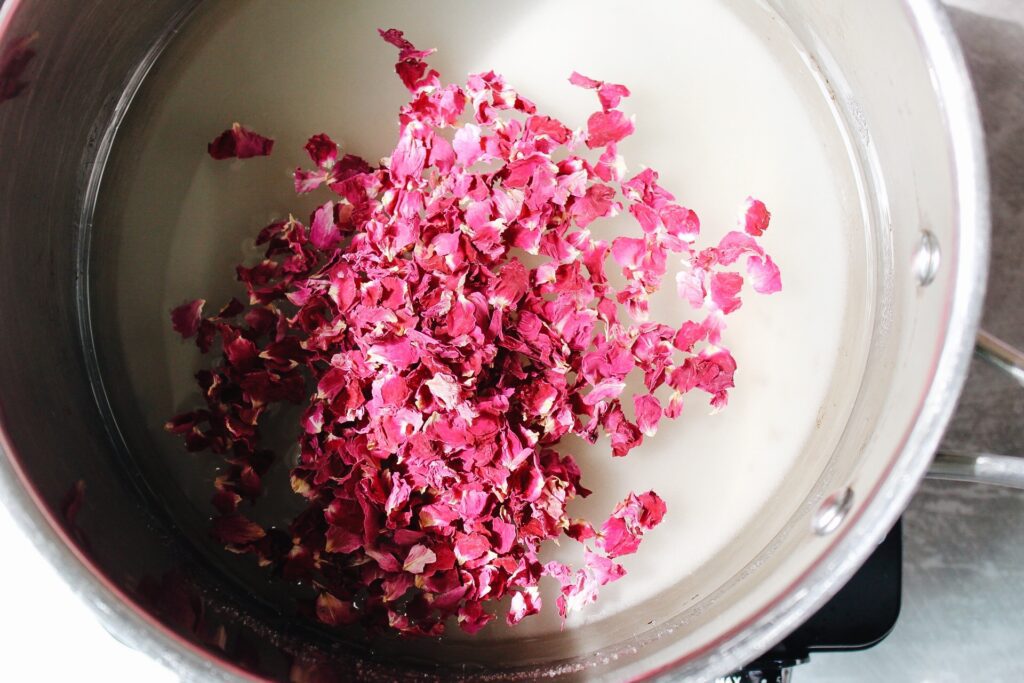 dried rose petals, sugar and water in a pot over medium heat