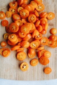 sliced kumquats on a cutting board