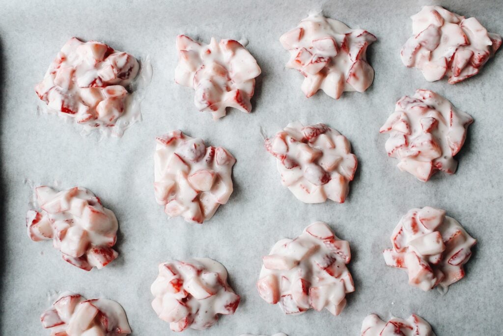 berry yogurt clusters on parchment ready to freeze