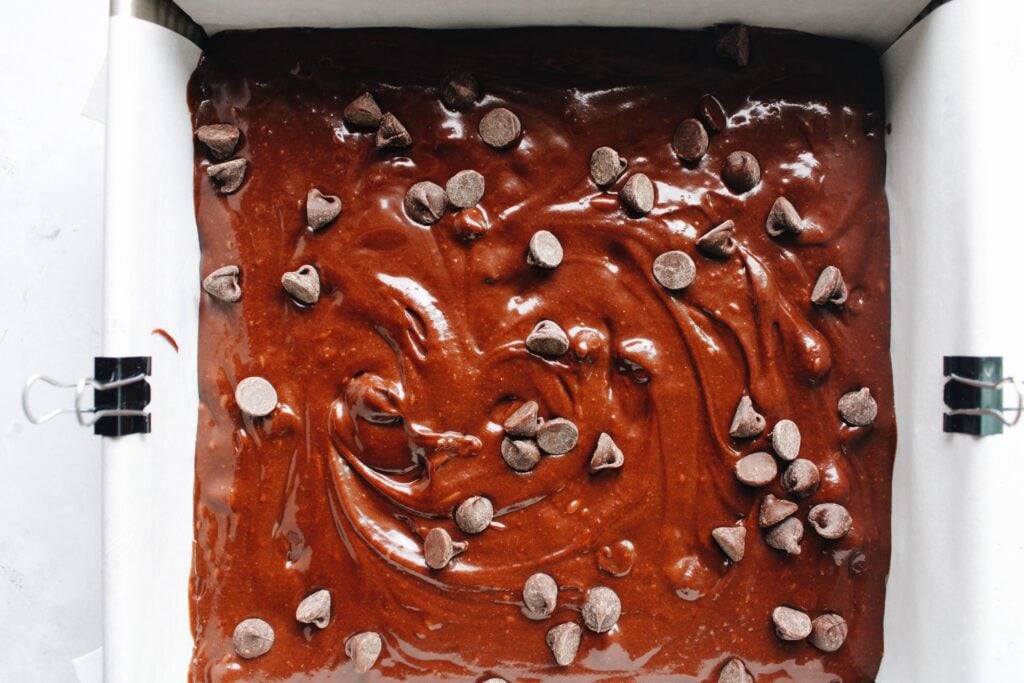 brownie batter spread in 8x8 metal baking dish