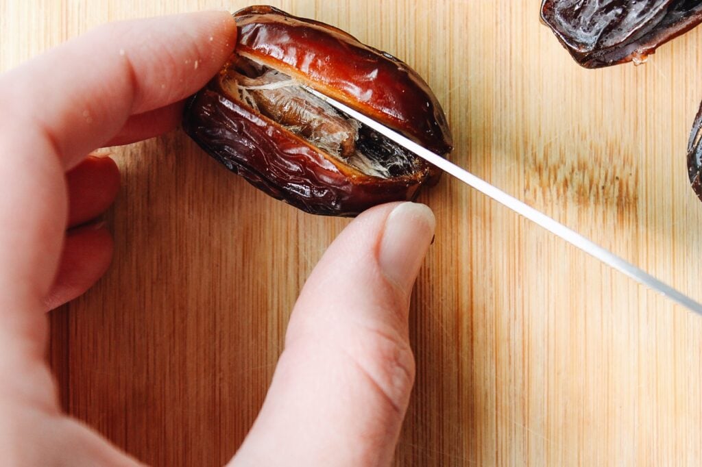 a medjool date with a slit cut down the middle to remove pit