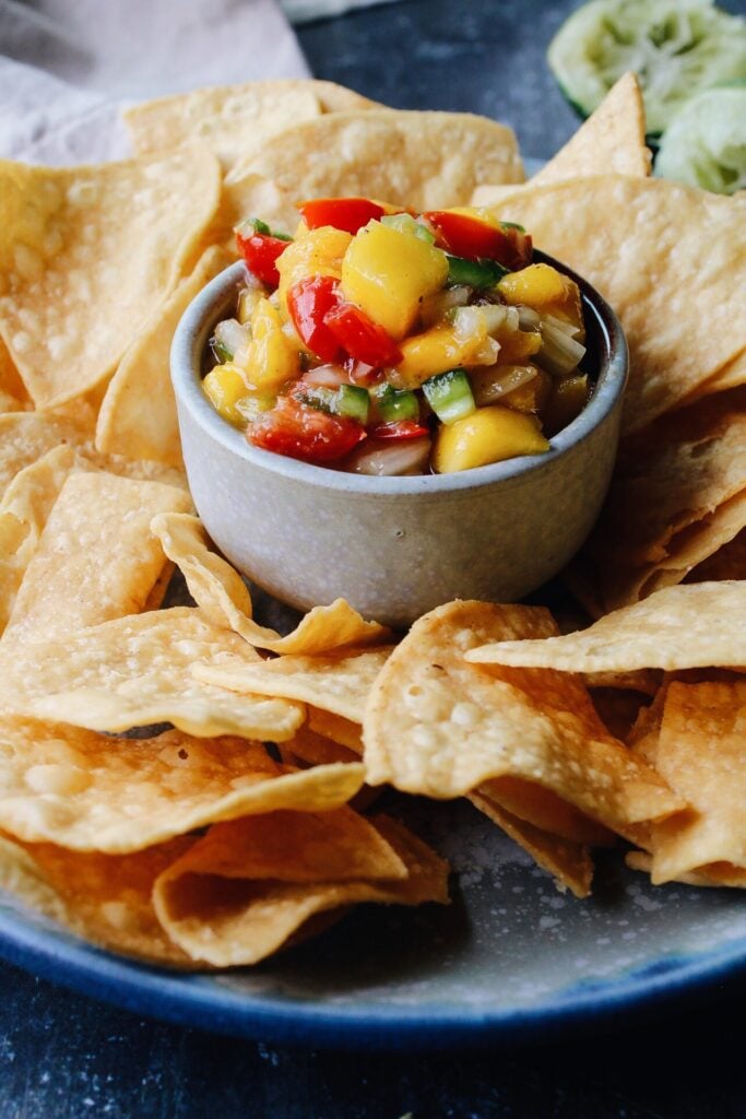 mango jalapeno salsa surrounded by chips in a chip/dip bowl