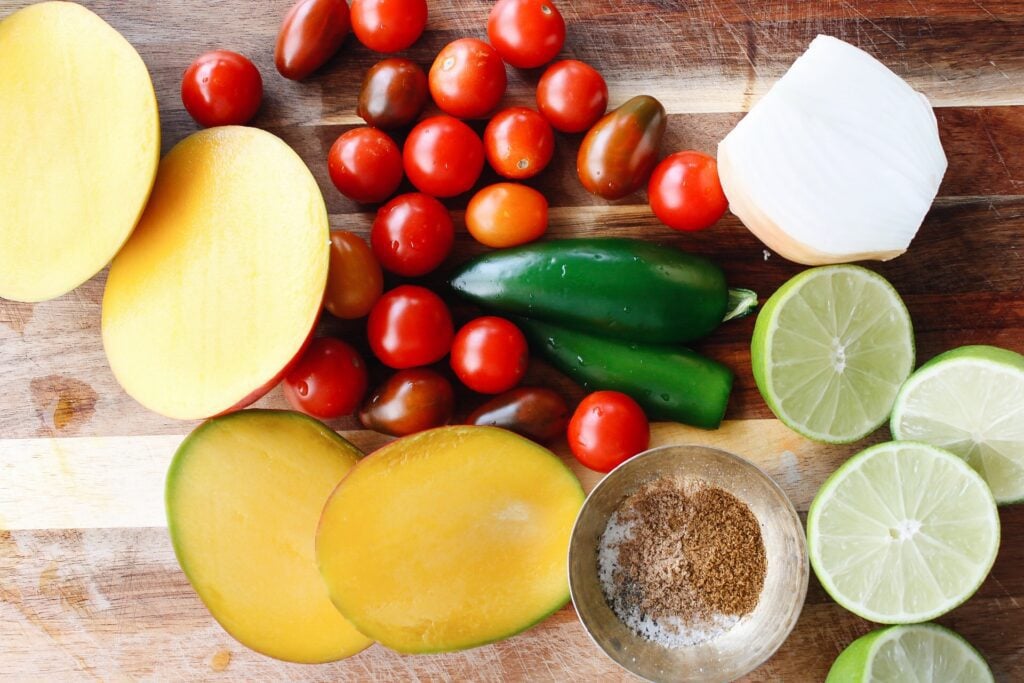 ingredients for mango salsa on a cutting board
