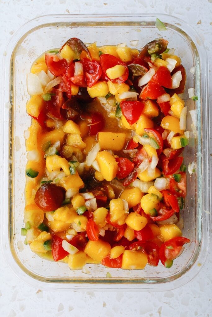 mango salsa in a glass storage container