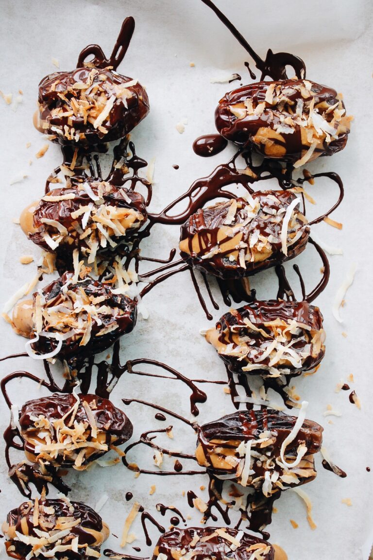 peanut butter stuffed dates drizzled with chocolate and sprinkled with toasted coconut