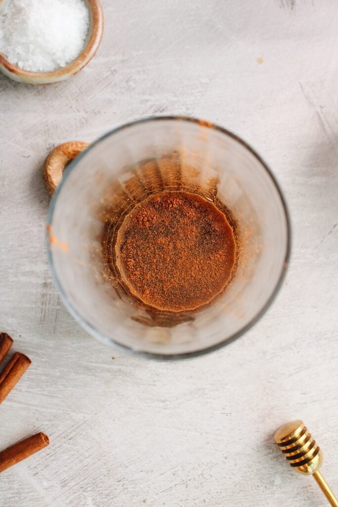 cinnamon added to hot coffee with honey