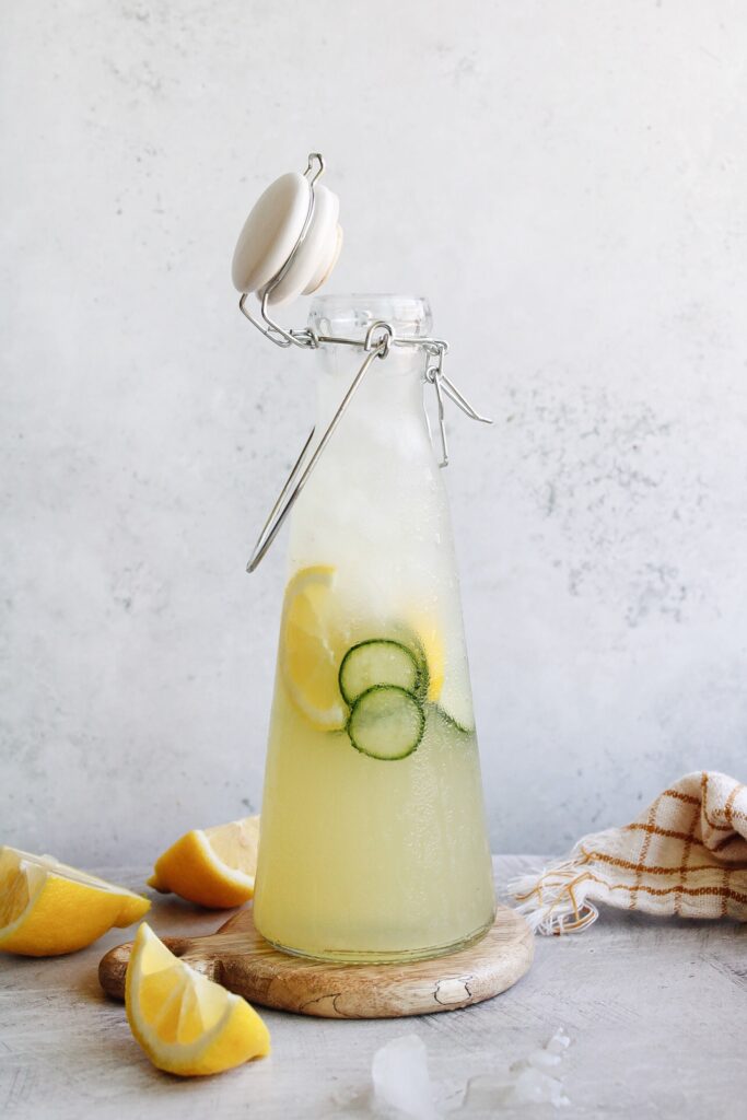 cucumber lemonade in a glass bottle with ice