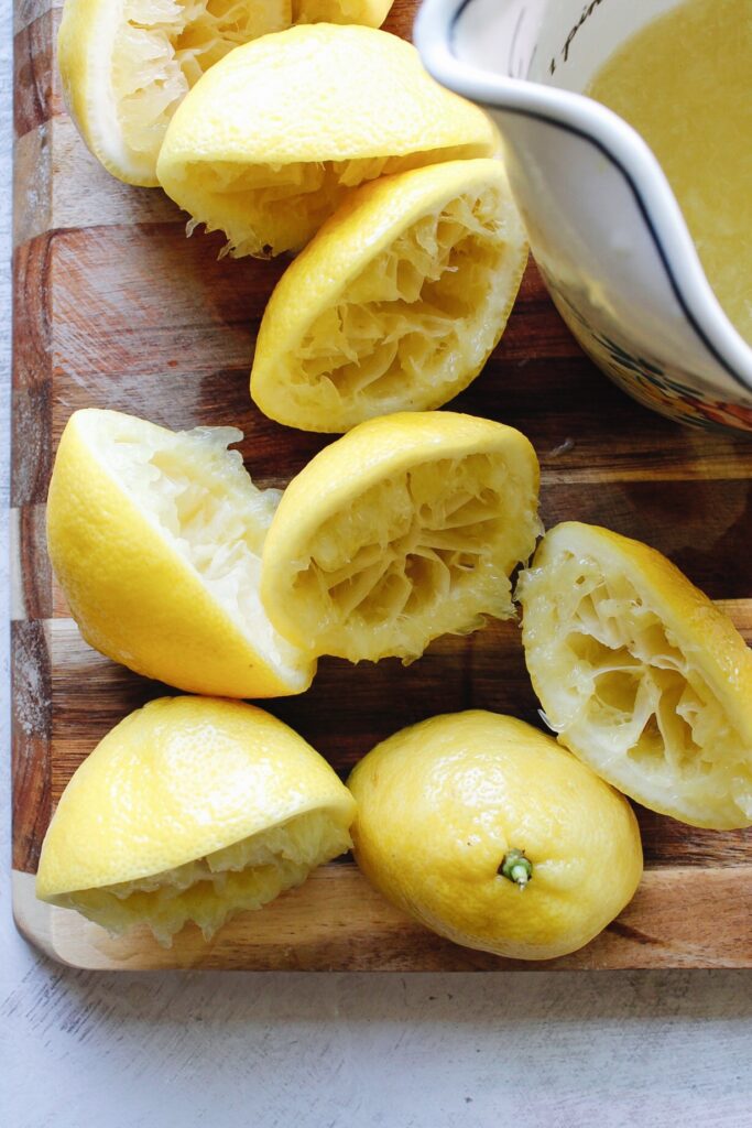 juiced lemons on cutting board