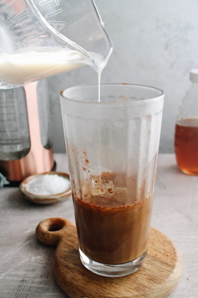 milk being added to honey cinnamon latte
