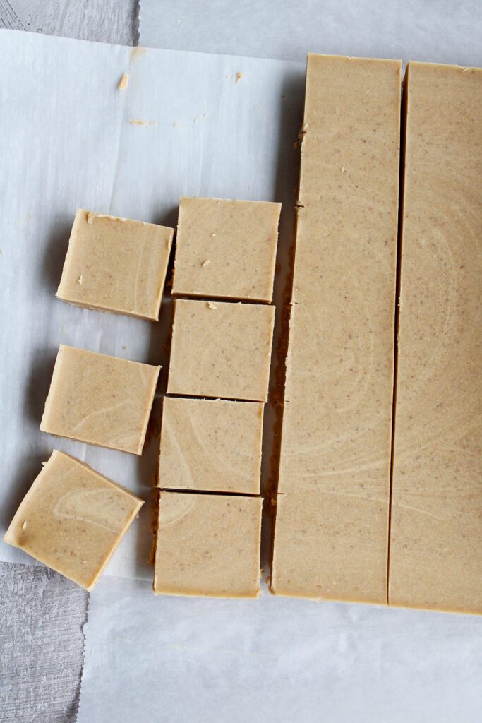 no bake peanut butter fudge in the process of being cut into squares
