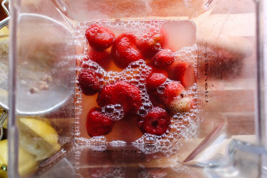 frozen strawberries, lemon juice and water in a blender