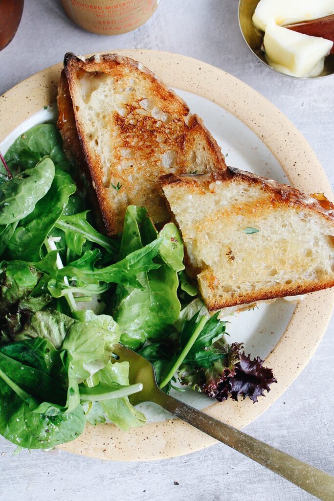 brie grilled cheese served with a salad