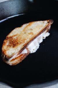 brie grilled cheese cooking in a skillet