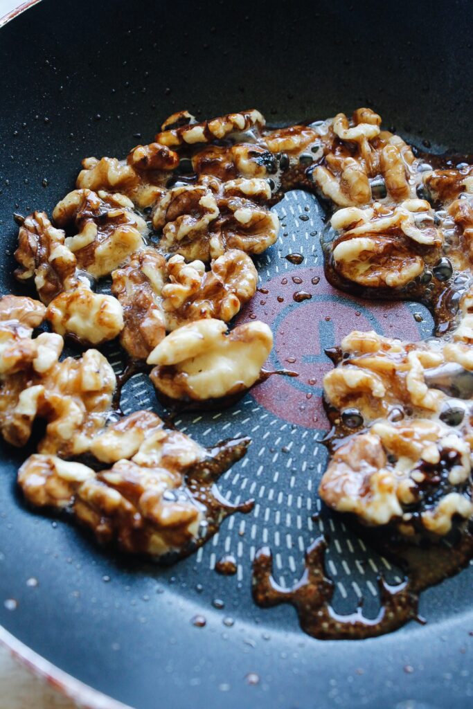 walnuts in a nontick pan with melted butter and sugar