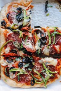 pizza with olives, green bell pepper and pepperoni
