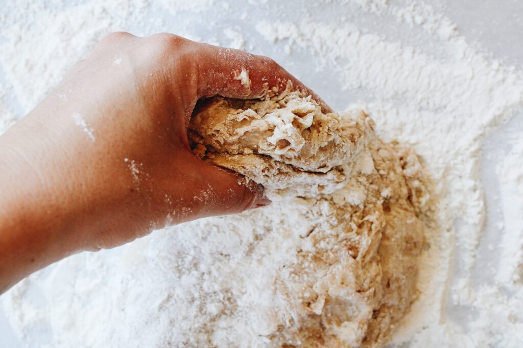 dough being folded and kneaded