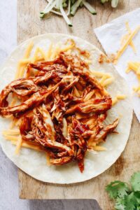 bbq chicken and cheddar cheese on a tortilla