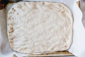 pizza dough pressed into baking pan