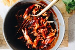 bbq sauce and chicken in a small gray bowl