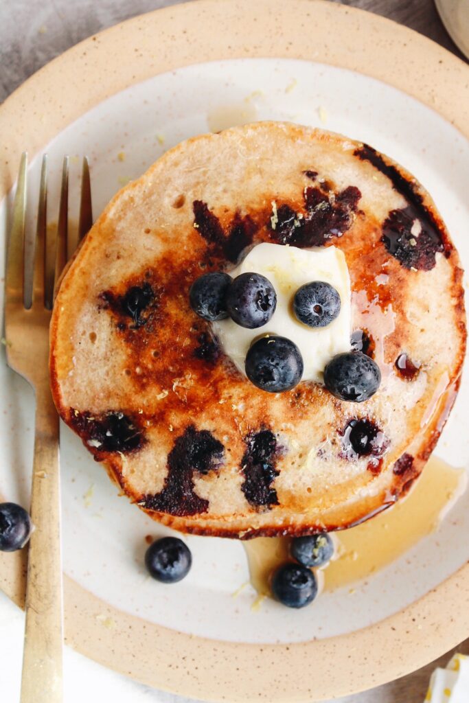 blueberry lemon pancakes with salted butter, maple syrup and fresh blueberries