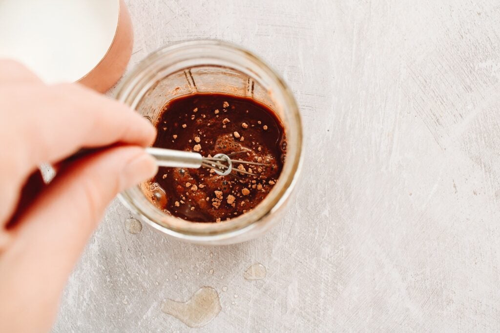 cocoa, mint syrup, salt and vanilla being whisked into brewed coffee