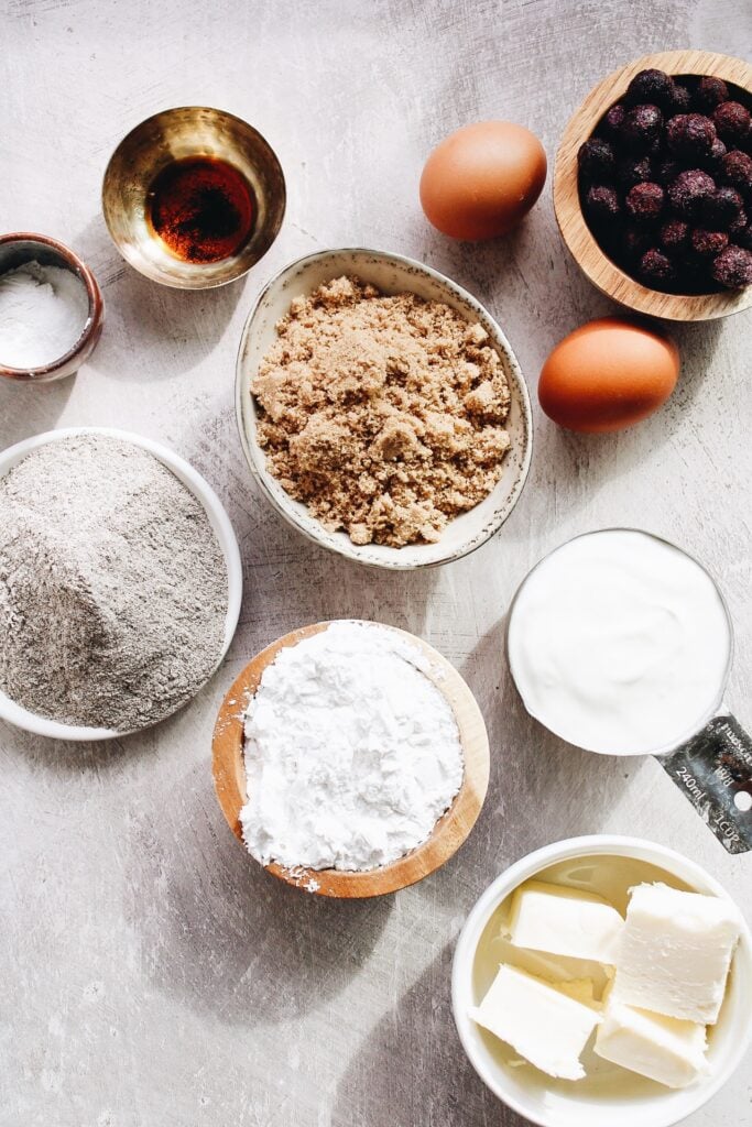 ingredients for blueberry buckwheat muffins laid out on a gray background