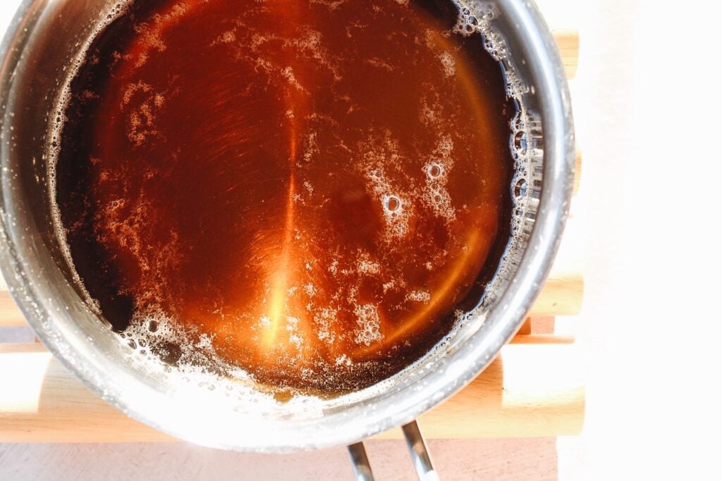 tea and sugar cooking in a small pot