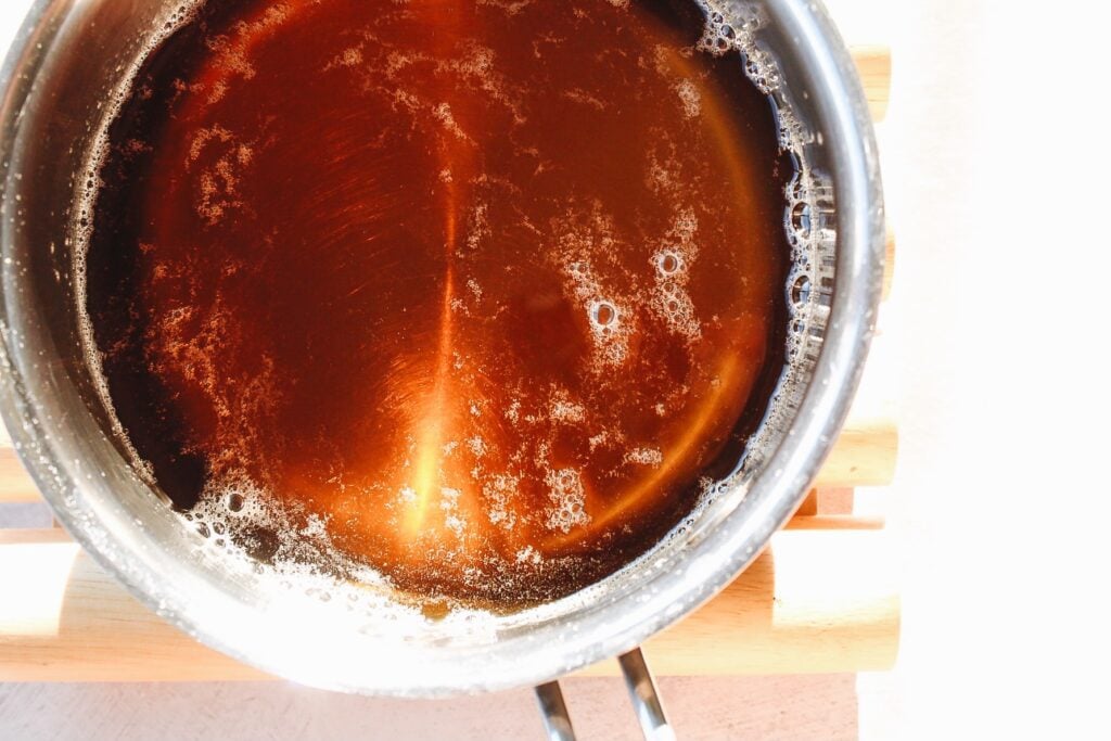 chamomile tea syrup cooking in a small pot